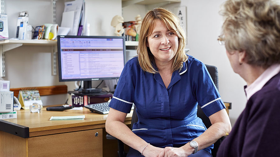 Jacky Mellis, a community research nurse, is in consultation with a patient